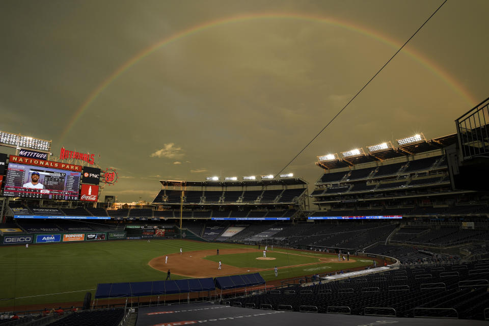 A rainbow is seen over Nationals park as the Washington Nationals compete against the Toronto Blue Jays during the eighth inning of a baseball game, Tuesday, July 28, 2020, in Washington. (AP Photo/Nick Wass)