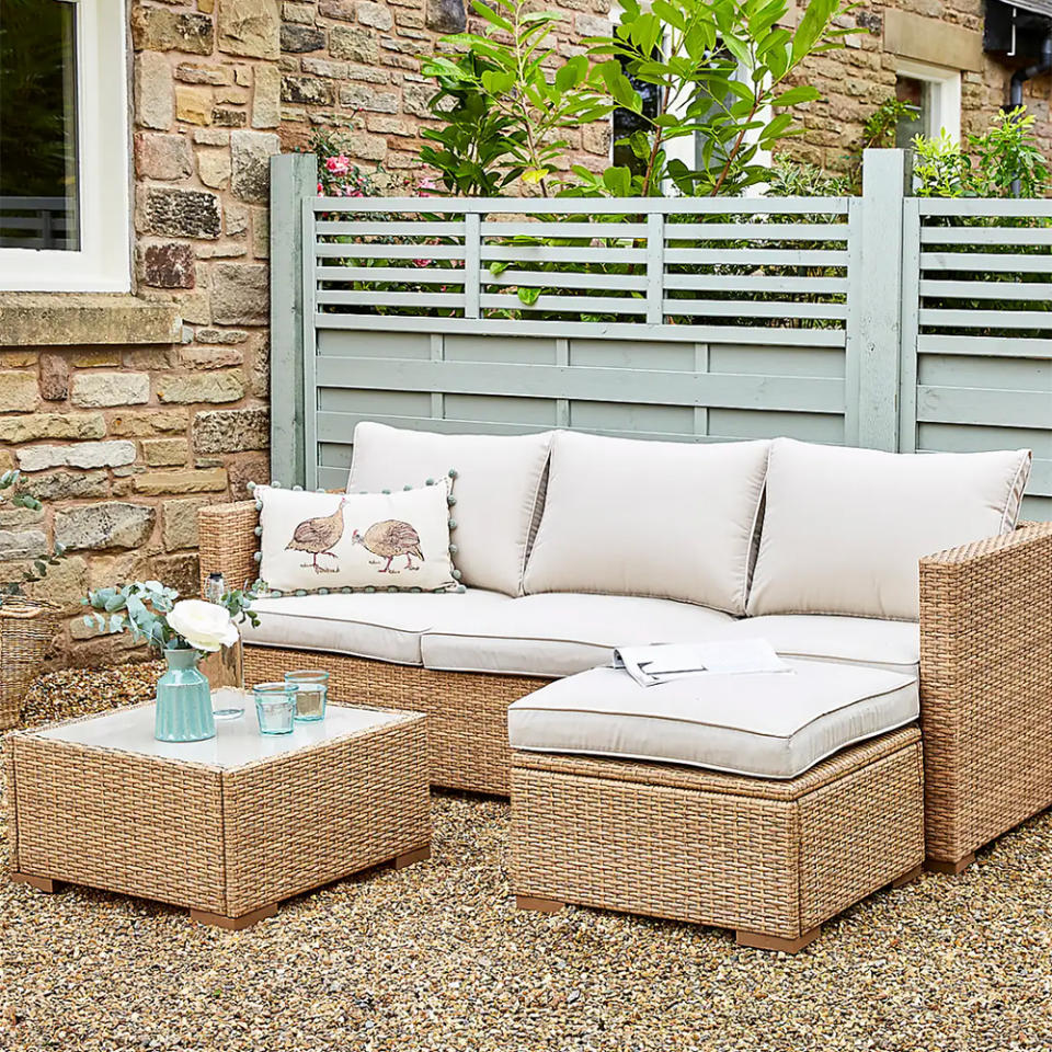 Natural rattan sofa set in a gravel garden