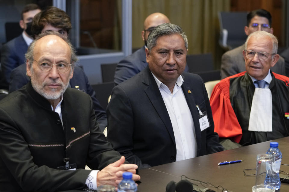 Bolivian Foreign Minister, Rogelio Mayta, center, waits for the reading of the verdict at the World Court in The Hague, Netherlands, Thursday, Dec. 1, 2022, where the UN's top court ruled on a dispute about a river that crosses Chile's and Bolivia's border, in a case seen as important jurisprudence at a time when fresh water is becoming an increasingly coveted world resource. (AP Photo/Peter Dejong)