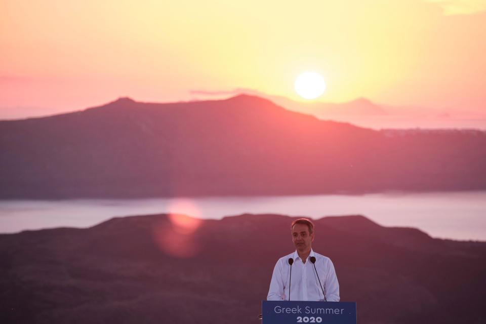 In this photo provided by the Prime Minister's Office, Greek Prime Minister Kyriakos Mitsotakis announces the opening of the tourist season during a news conference, on the Greek island of Santorini, Saturday, June 13, 2020. (Dimitris Papamitsos/Greek Prime Minister's Office via AP)