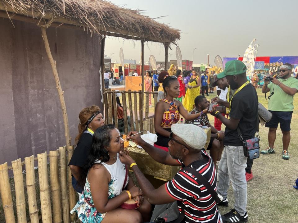 Attendees get their faces painted at the 2022 Afrochella Festival on Dec. 28, 2022 at El Wak Stadium in the greater Accra region of Ghana. (theGrio Photo/Chinekwu Osakwe)