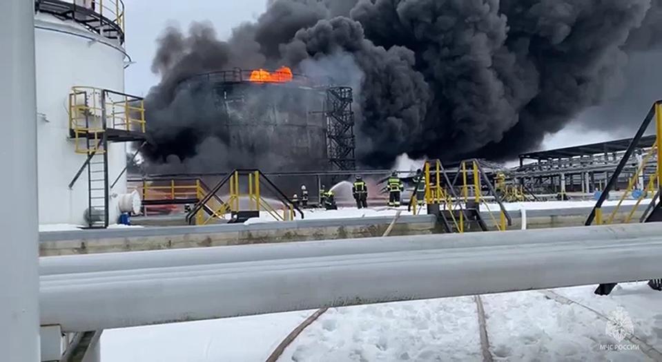 In this photo taken from video released by Governor of Bryansk Region Alexander Bogomaz telegram channel AV BogomaZ on Friday, Jan. 19, 2024, Russian Emergency Ministry employees work at the side of fire of oil reservoirs after the drone reached Klintsy, a city in Bryansk Region of Russia, about 60 kilometers (40 miles) from the Russia-Ukrainian border. A Russian official says a Ukrainian drone has struck an oil storage depot in western Russia, causing a massive blaze. (Governor of Bryansk Region Alexander Bogomaz telegram channel AV BogomaZ via AP)