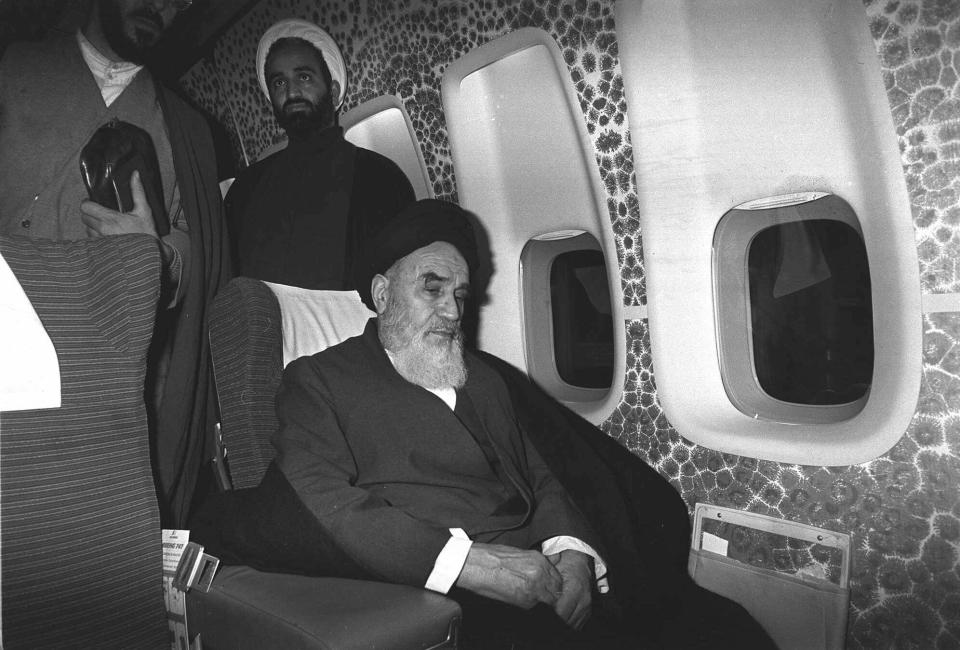 FILE - In this Feb. 1, 1979 file photograph, Ayatollah Ruhollah Khomeini sits inside the chartered airplane which will fly him back to Iran, a few minutes before the plane took off from Paris, France. Friday, Feb. 1, 2019, marks the 40th anniversary of Iran’s exiled Ayatollah Ruhollah Khomeini return to Tehran, a moment that changed the country’s history for decades to come. That revolution would spark the U.S. Embassy takeover and hostage crisis, stoking the animosity that exists between Tehran and Washington to this day. (AP Photo/Campion, File)