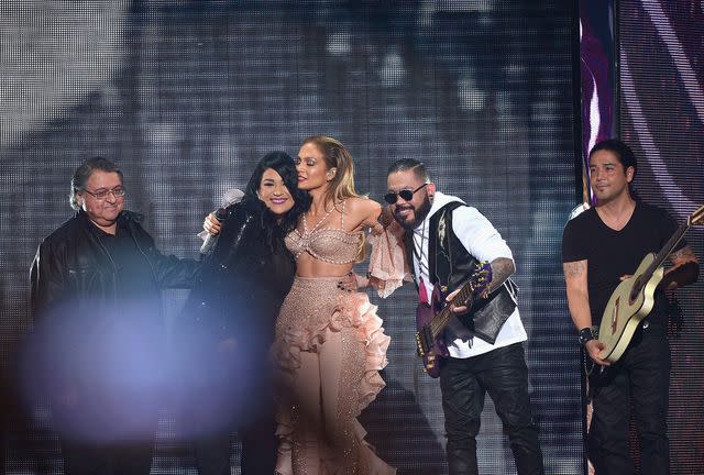 <p>Rodrigo Varela/Getty</p> Jennifer Lopez, Ricky Vela, Suzette Quintanilla, A.B. Quintanilla III and Chris Pérez onstage after performing a musical tribute to Selena at the 2015 Billboard Latin Music Awards.