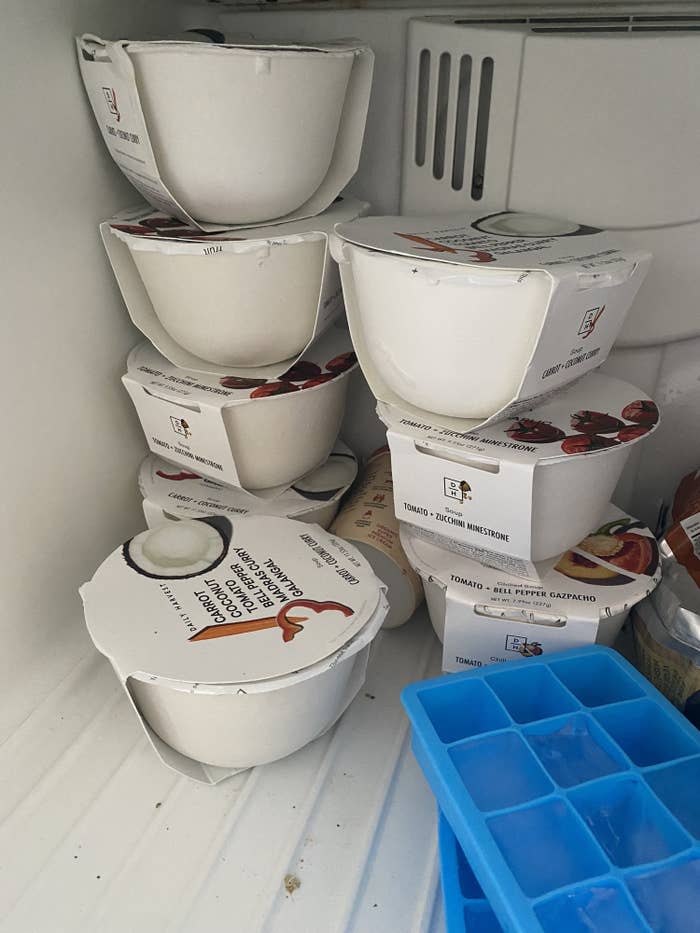 Eight Daily Harvest meals stacked on top of each other in Shelby's freezer