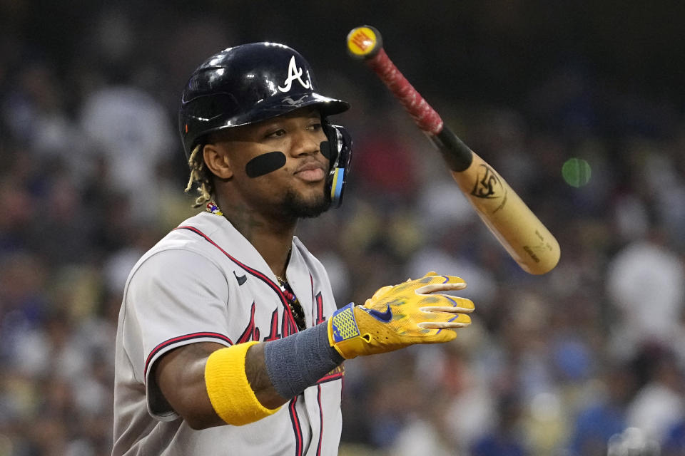 Atlanta Braves' Ronald Acuna Jr. tosses his bat after walking during the first inning of a baseball game against the Los Angeles Dodgers Friday, Sept. 1, 2023, in Los Angeles. (AP Photo/Mark J. Terrill)