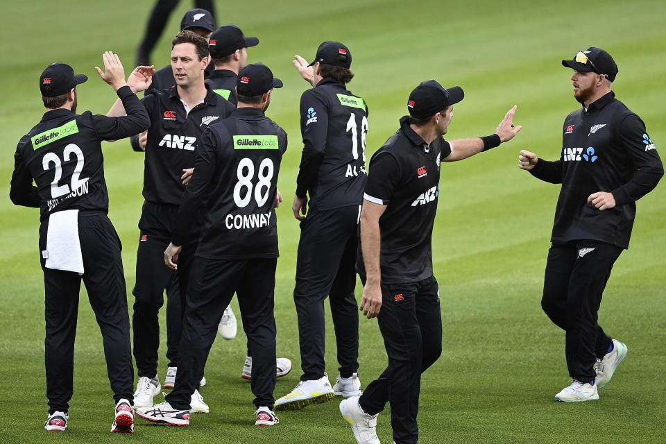 New Zealand's Matt Henry, second left, celebrates with teammates after the dismissal of India's Shikhar Dhawan during their one day international cricket match in Hamilton, New Zealand, Sunday, Nov. 27, 2022. (Andrew Cornaga/Photosport via AP)