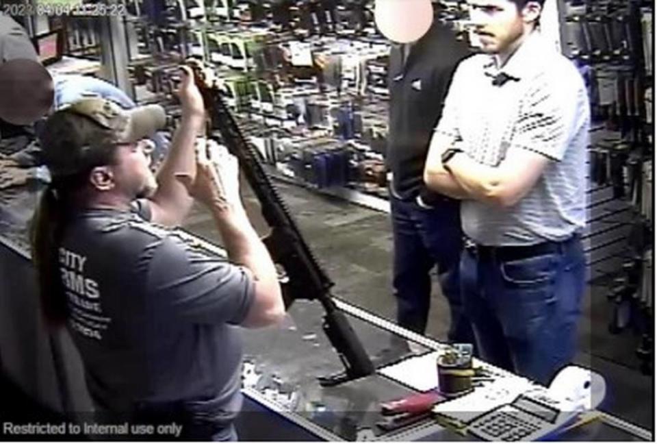 Connor Sturgeon looks at a firearm inside River City Firearms on April 4, 2023.