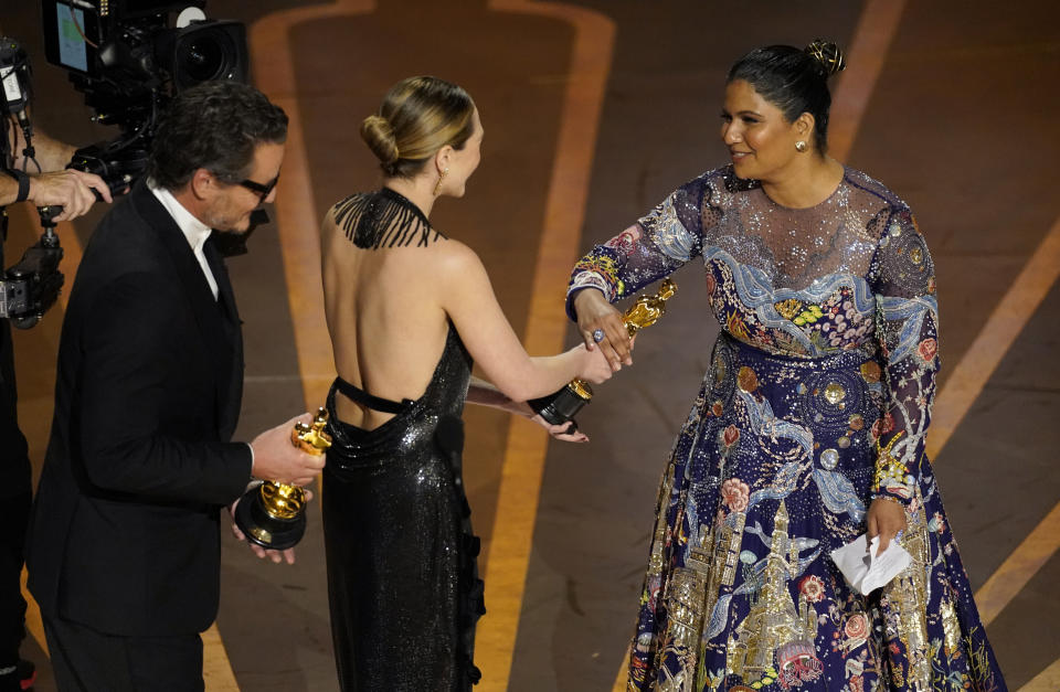 Pedro Pascal, from left, and Elizabeth Olsen present Kartiki Gonsalves with the award for best documentary short film for "The Elephant Whisperer" at the Oscars on Sunday, March 12, 2023, at the Dolby Theatre in Los Angeles. (AP Photo/Chris Pizzello)