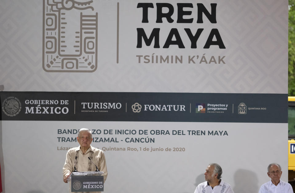Mexican President Andres Manuel Lopez Obrador, left, speak during a ceremony in Lazaro Cardenas, Quintana Roo state, Mexico, Monday, June 1, 2020. Amid a pandemic and the remnants of a tropical storm, President Lopez Obrador kicked off Mexico's return to a "new normal" Monday with his first road trip in two months as the nation began to gradually ease some virus-inspired restrictions. (AP Photo/Victor Ruiz)