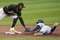 Pittsburgh Pirates shortstop Oneil Cruz, left, tags out Milwaukee Brewers' Blake Perkins attempting to steal second during the second inning of a baseball game in Pittsburgh, Wednesday, April 24, 2024. (AP Photo/Gene J. Puskar)