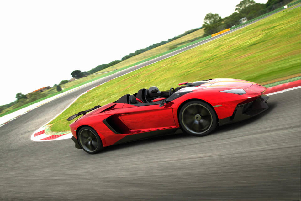 Starting with the everyday 700-hp Aventador, Lamborghini taunted the bull even further by removing the roof, adding several aerodynamic panels and generally shucking weight from a car that only had 3,472 lbs. to begin with. Even the seat fabrics have been swapped for something Lamborghini calls "Carbonskin," a fabric made from carbon fibers that's at least a decade away from being used on a teenager's hat. With no windshield, the interior has to get some form of waterproofing; the rear mirror pops up like Wall-E's head from the center of the dash. It and the roll bars behind the driver are the highest points in the car.