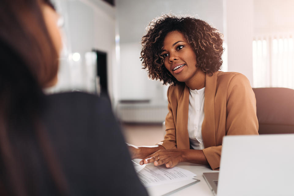 Young woman doing a job interview in the office and talking with client