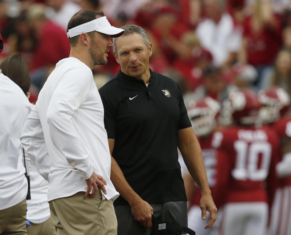 Oklahoma head coach Lincoln Riley, left, talks with Army head coach Jeff Monken, right, before an NCAA college football game in Norman, Okla., Saturday, Sept. 22, 2018. (AP Photo/Sue Ogrocki)