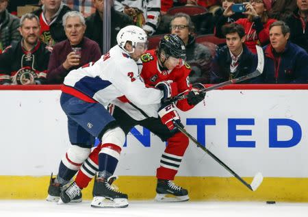 Jan 20, 2019; Chicago, IL, USA; Chicago Blackhawks right wing Patrick Kane (88) battles for the puck with Washington Capitals defenseman Matt Niskanen (2) during the first period at United Center. Mandatory Credit: Kamil Krzaczynski-USA TODAY Sports