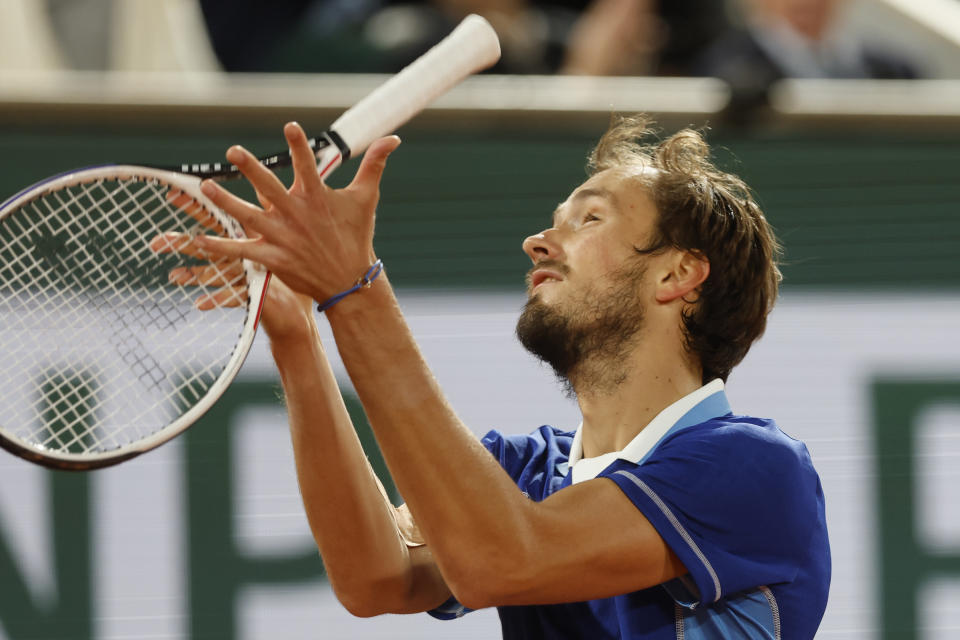 Russia's Daniil Medvedev throws his racket up in the air as he plays Croatia's Marin Cilic during their fourth round match of the French Open tennis tournament at the Roland Garros stadium Monday, May 30, 2022 in Paris. (AP Photo/Jean-Francois Badias)