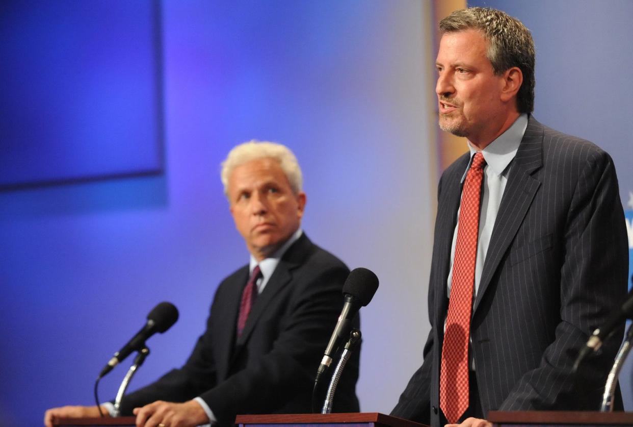 Bill de Blasio (r.), Democratic hopeful for the office of the New York City Public Advocate, speaks from the podium as opponent Mark Green looks on during a debate at the WNYC studios in New York on September 8, 2009.