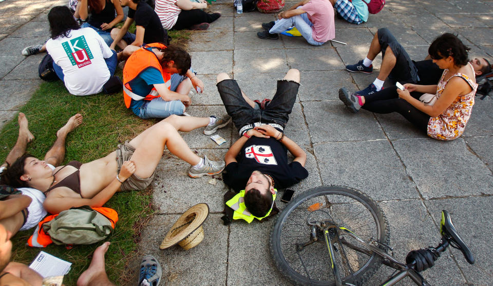 Protesters rest after traveling to Madrid from many parts of Spain to demonstrate against the country's near 25 percent unemployment rate and stinging austerity measures introduced by the government in Madrid, Spain, Saturday, July 21, 2012. (AP Photo/Andres Kudacki)