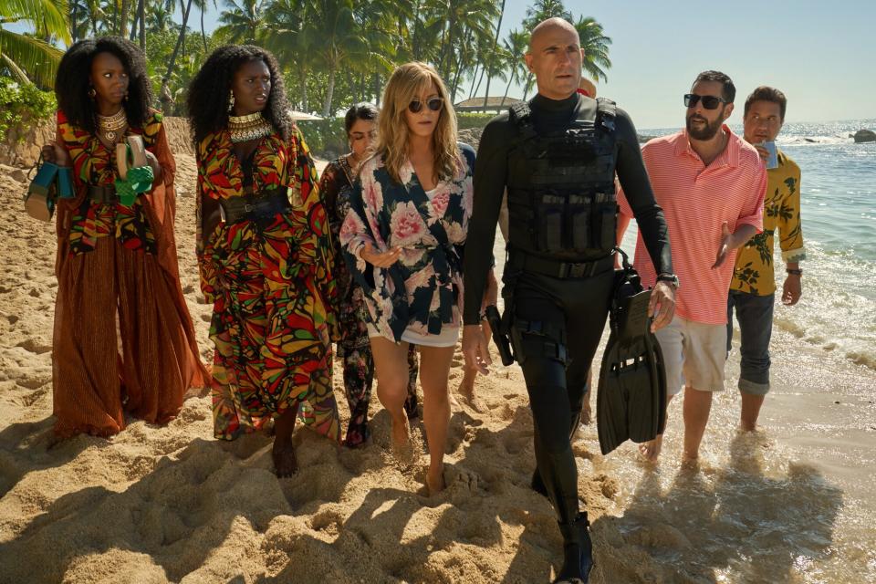 Murder Mystery 2. (L-R) Zurin Villanueva as Imani, Jodie Turner-Smith as Countess, Kuhoo Verma as Saira, Jennifer Aniston as Audrey Spitz, Mark Strong as Miller, Adam Sandler as Nick Spitz and Enrique Arce as Francisco in Murder Mystery 2.