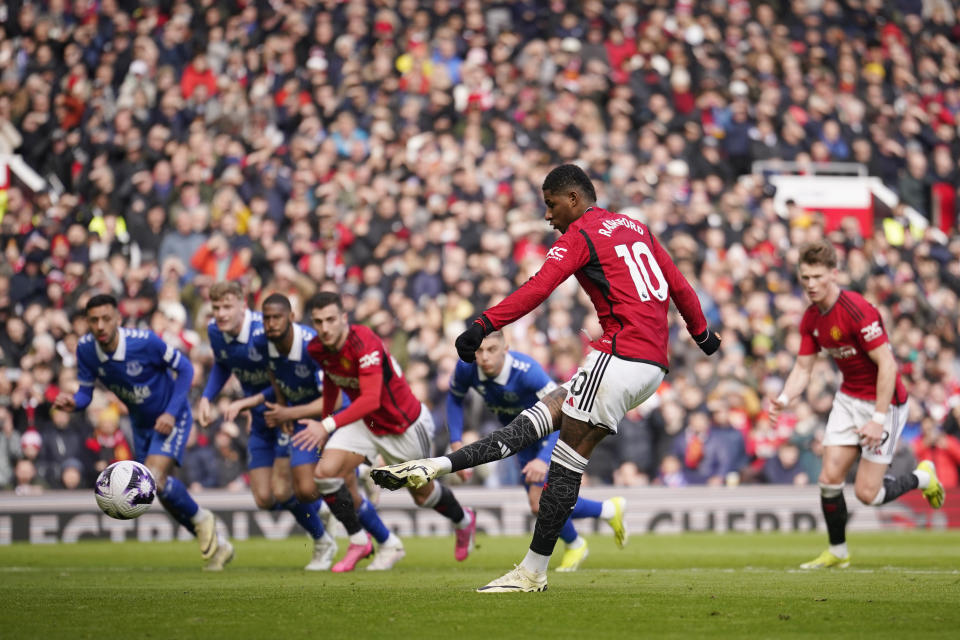 Manchester United's Marcus Rashford, 2nd from right, scores his side's second goal with a penalty kick during an English Premier League soccer match between Manchester United and Everton at the Old Trafford stadium in Manchester, England, Saturday, March 9, 2024. (AP Photo/Dave Thompson)