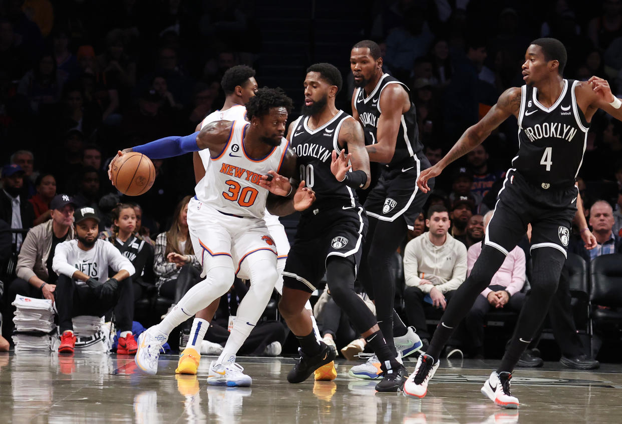 NEW YORK, NEW YORK - NOVEMBER 09:  Julius Randle #30 of the New York Knicks drives against Royce O'Neale #00 of the Brooklyn Nets during their game at Barclays Center on November 09, 2022 in New York City.  User expressly acknowledges and agrees that, by downloading and or using this photograph, User is consenting to the terms and conditions of the Getty Images License Agreement.  (Photo by Al Bello/Getty Images)