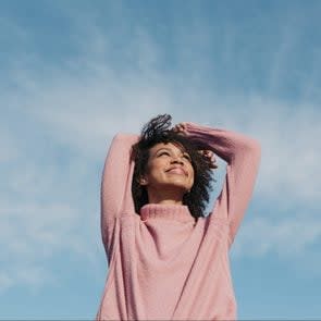 Portrait Of Happy Young Woman Enjoying Sunlight