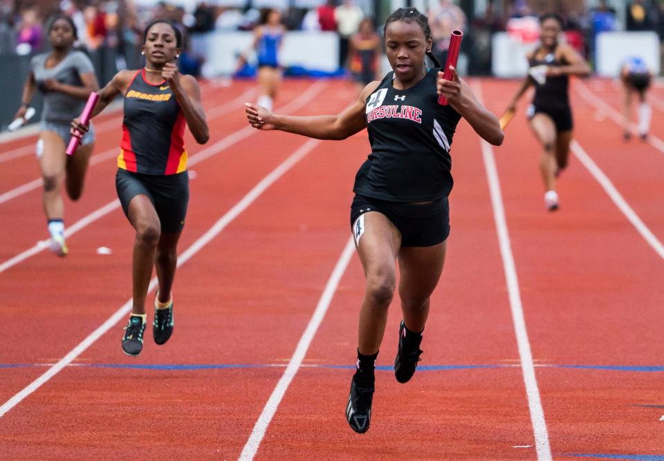 Ursuline's Najiya Cornish crosses the finish line to give her team a win in the Division II Girls 4x100 Meter Relay event at the DIAA Outdoor Track and Field Championships at Dover High School in Dover in 2016.