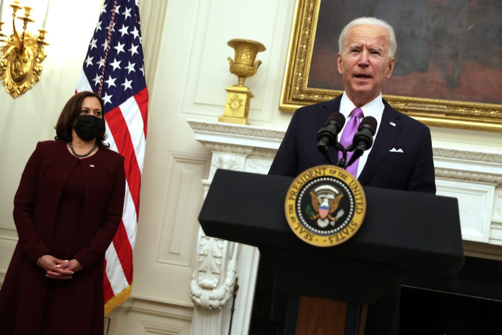 U.S. President Joe Biden speaks as Vice President Kamala Harris looks on during an event at the State Dining Room of the White House January 21, 2021 in Washington, DC. (Photo by Alex Wong/Getty Images)