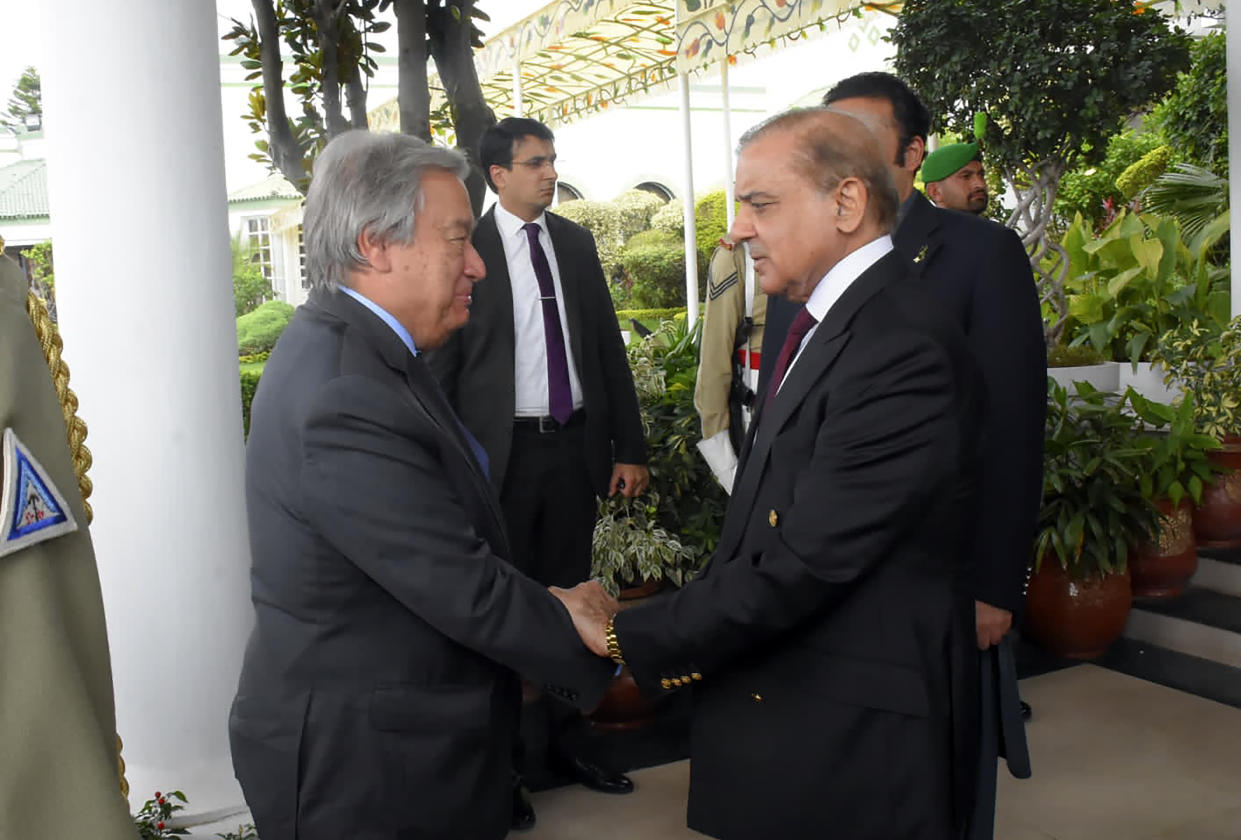 In this handout photo released by Pakistan Prime Minister Office, U.N. Secretary-General Antonio Guterres, left, shake hand with Pakistan Prime Minister Shahbaz Sharif in Islamabad, Pakistan, Friday, Sept. 9, 2022. Guterres appealed to the world to help Pakistan after arriving in the country Friday to see climate-induced devastation from months of deadly record floods that have left half a million people living in tents under the open sky. (Pakistan Prime Minister Office via AP)