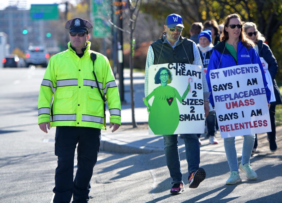 Ken LeBlanc of Clinton walks alongside his wife, Carla, on the picket line at St. Vincent Hospital on Nov. 7.