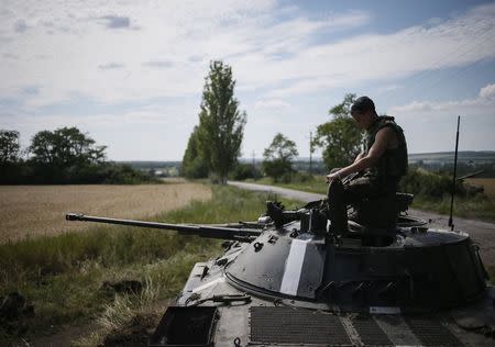 A Ukrainian soldier sits on an armoured vehicle at a position near the eastern Ukrainian city of Konstantinovka July 10, 2014. REUTERS/Gleb Garanich