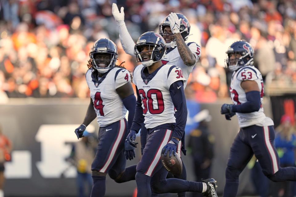 Houston Texans safety DeAndre Houston-Carson (30) celebrates with teammates after intercepting a pass against the Cincinnati Bengals during the second half of an NFL football game Sunday, Nov. 12, 2023, in Cincinnati. (AP Photo/Carolyn Kaster)