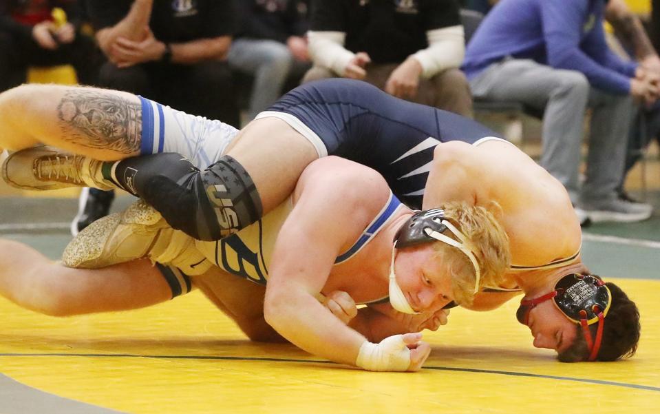 Archbishop Hoban's Brayton Feister works his way to a pin against Brunswick's Dominic May in the 215 pound championship round of Bill Dies Memorial wrestling tournament at Firestone High School on Saturday Jan. 13, 2024.