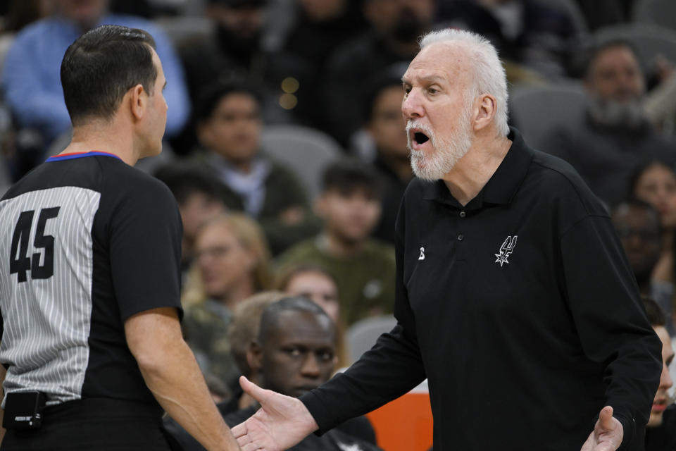 San Antonio Spurs head coach Gregg Popovich, right, speaks with referee Brian Forte during the second half of an NBA basketball game against the Utah Jazz, Monday, Dec. 26, 2022, in San Antonio. (AP Photo/Darren Abate)