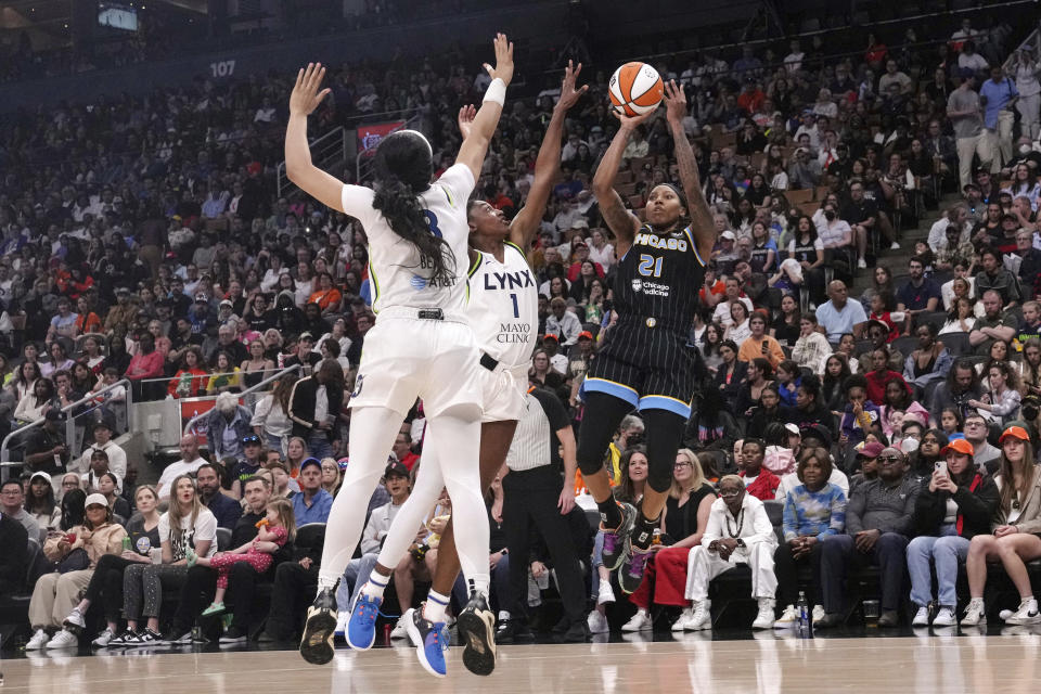 Chicago Sky's Robyn Parks (21) shoots over Minnesota Lynx's Diamond Miller and Brea Beal, left, during the second half of a preseason WNBA basketball game in Toronto, Saturday May 13, 2023. (Chris Young/The Canadian Press via AP)