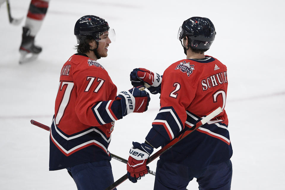 Washington Capitals right wing T.J. Oshie (77) celebrates his goal with defenseman Justin Schultz (2) during the first period of an NHL hockey game against the New Jersey Devils on Tuesday, March 9, 2021, in Washington. (AP Photo/Nick Wass)