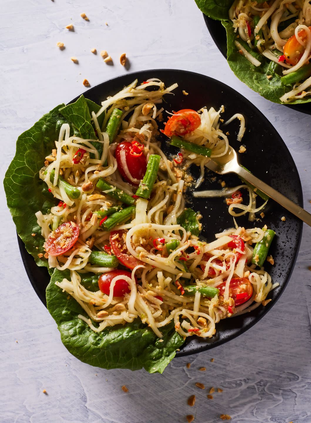 green papaya salad with tomatoes and romaine and crushed peanuts