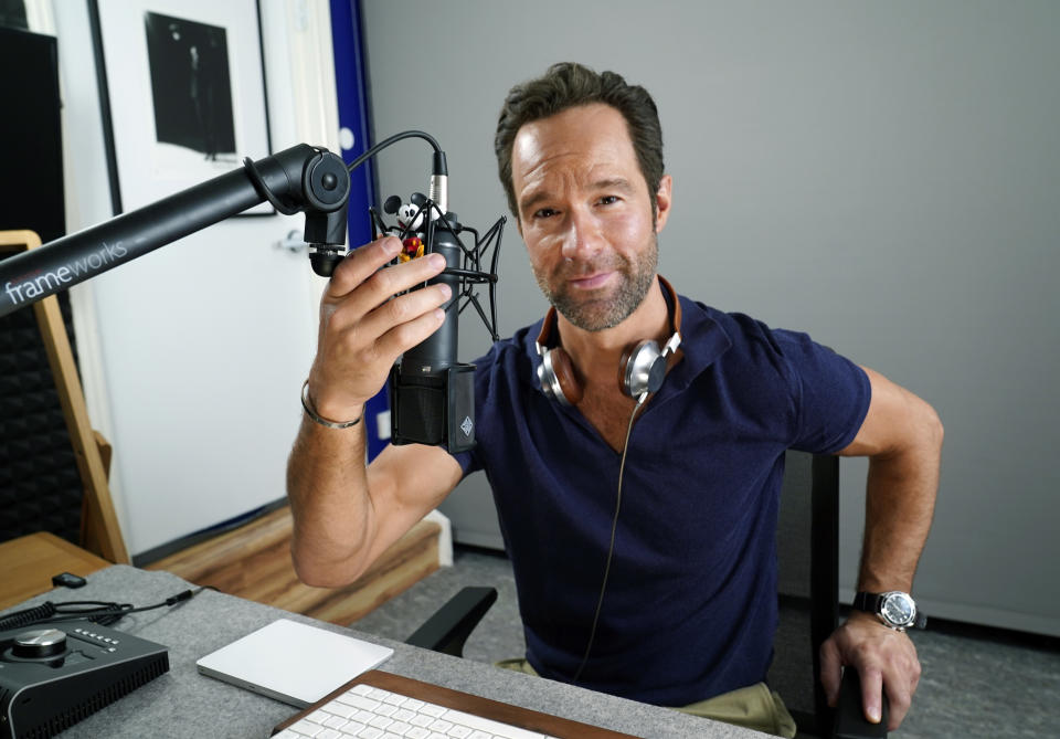 Actor and voiceover artist Chris Diamantopoulos poses for a portrait in his home studio in Los Angeles on Nov. 5, 2021. Diamantopoulos stars in the Netflix film "Red Notice." (AP Photo/Chris Pizzello)