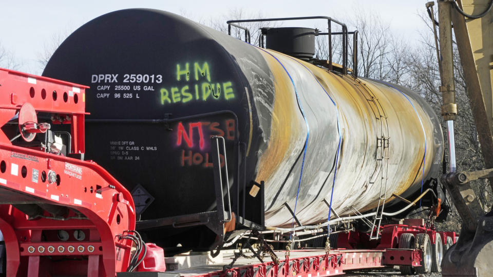 A tank car sits on a trailer as the cleanup of portions of a Norfolk Southern freight train that derailed over a week ago continues in East Palestine, Ohio, Wednesday, Feb. 15, 2023. (AP Photo/Gene J. Puskar)