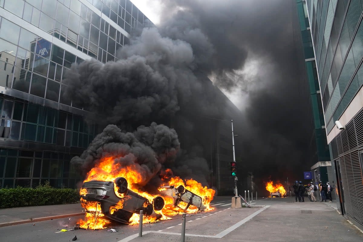 Cars burn after a march for Nahel (Copyright 2023 The Associated Press. All rights reserved.)