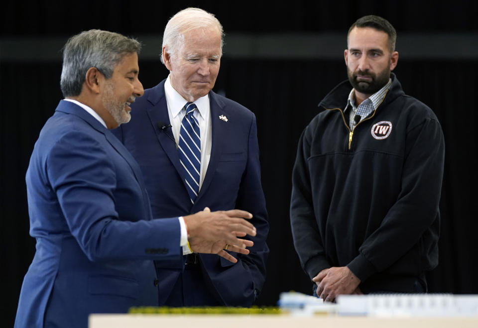 President Joe Biden listens as Sanjay Mehrotra, CEO of Micron Technology, left, speaks during a tour of Micron Pavilion at Onondaga Community College in Syracuse, N.Y., Thursday, Oct. 27, 2022. AP Photo/Manuel Balce Ceneta)