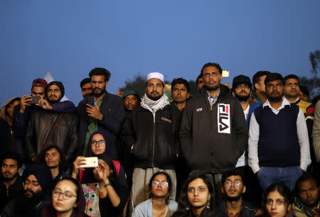 People watch artists performing on a stage at an event titled "Artists Unite", during which various artists signed to register their concern against hate and intolerance, at a public park in New Delhi, March 2, 2019. REUTERS/Anushree Fadnavis/Files