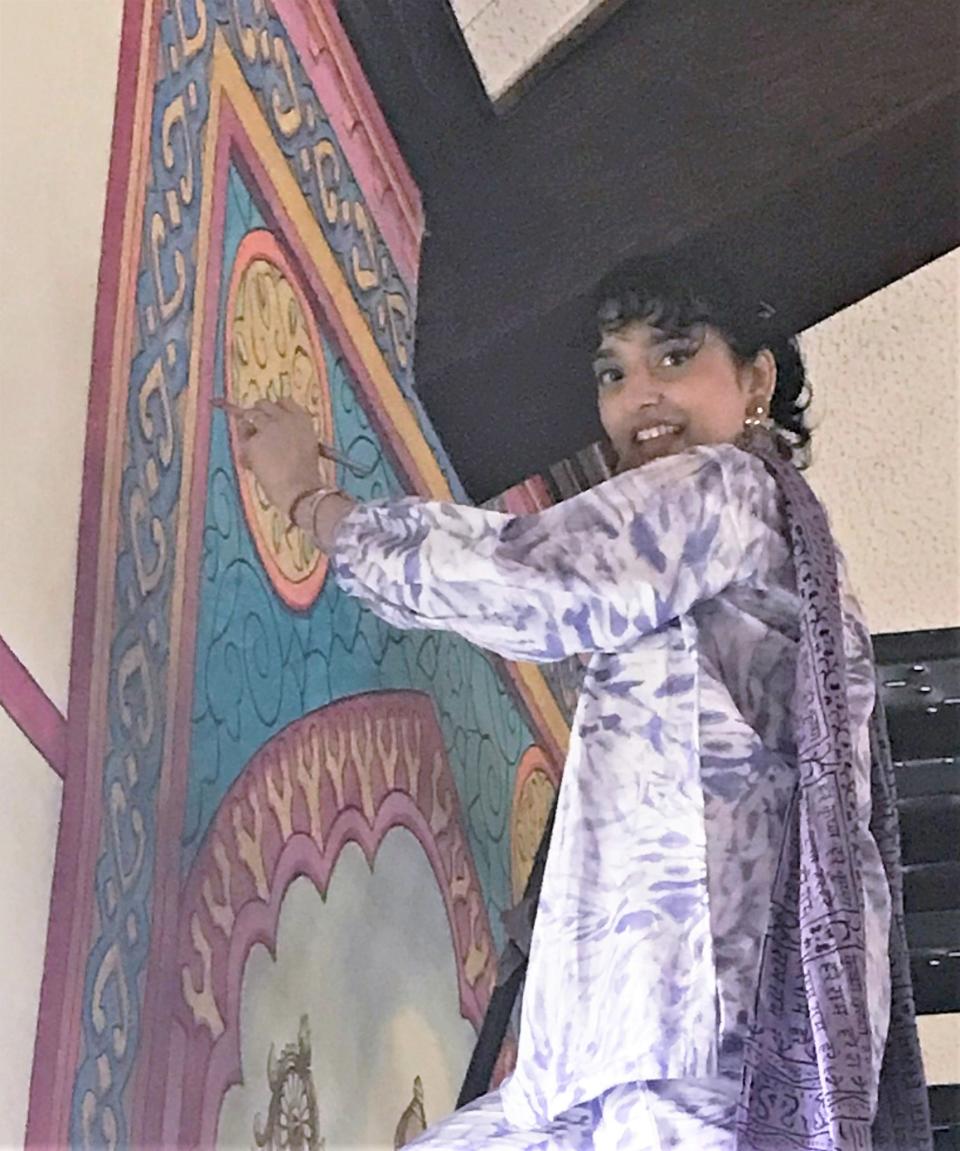 Rida Rais works on a mural at the new Paranitya Narasimha Temple, located in the former Our Lady of Lourdes Catholic Church in West Elmira.