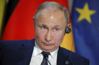 Russian President Vladimir Putin attends a joint press conference with Ukraine's President Volodymyr Zelenskiy, French President Emmanuel Macron and German Chancellor Angela Merkel at the Elysee Palace in Paris, Monday Dec. 9, 2019. Russian President Vladimir Putin and Ukrainian President Volodymyr Zelenskiy met for the first time Monday at a summit in Paris to try to end five years of war between Ukrainian troops and Russian-backed separatists. (Charles Platiau/Pool via AP)