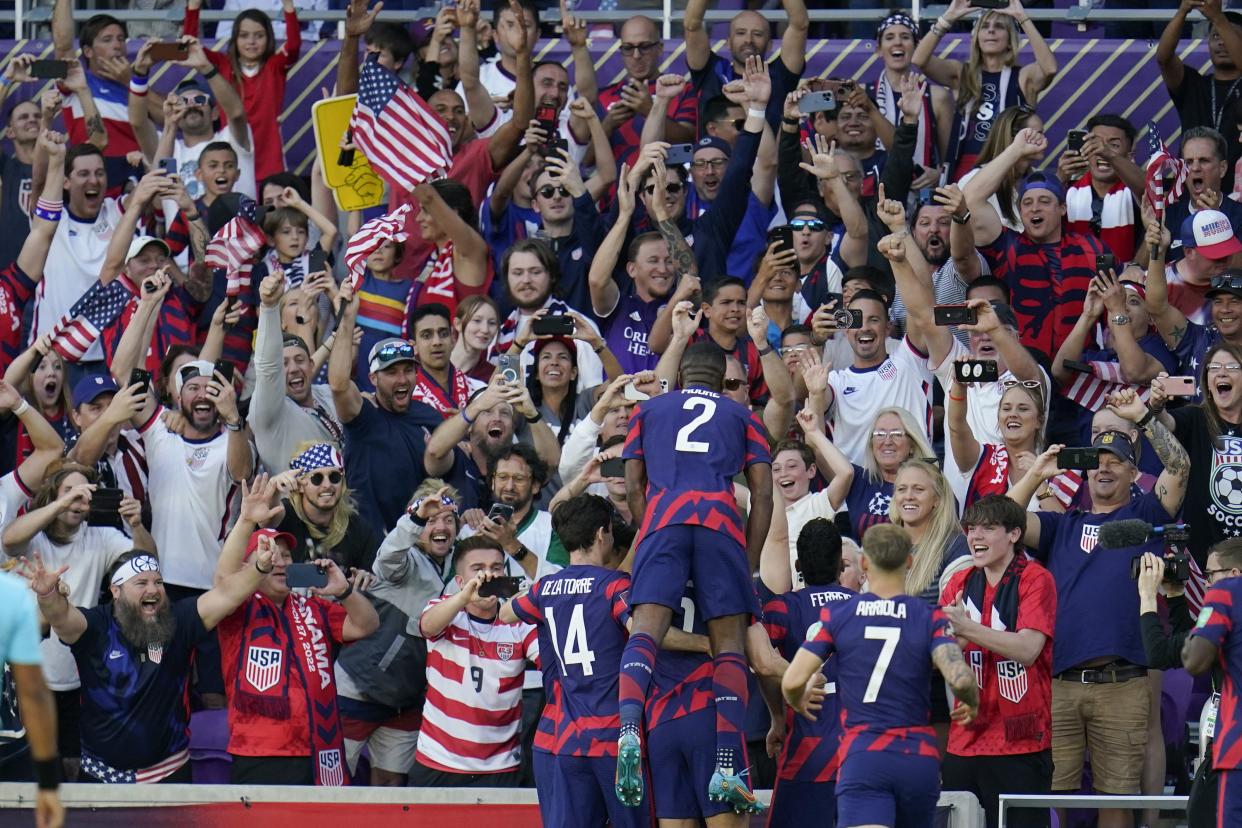 United States players celebrate near fans after Christian Pulisic scored on a penalty kick during the first half of a FIFA World Cup qualifying soccer match between Panama and the United States, Sunday, March 27, 2022, in Orlando, Fla. The U.S. won 5-1. 