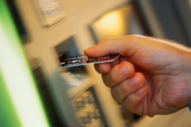 <p>Chronis Jons / Getty Images</p> Stock image of a person using an ATM card