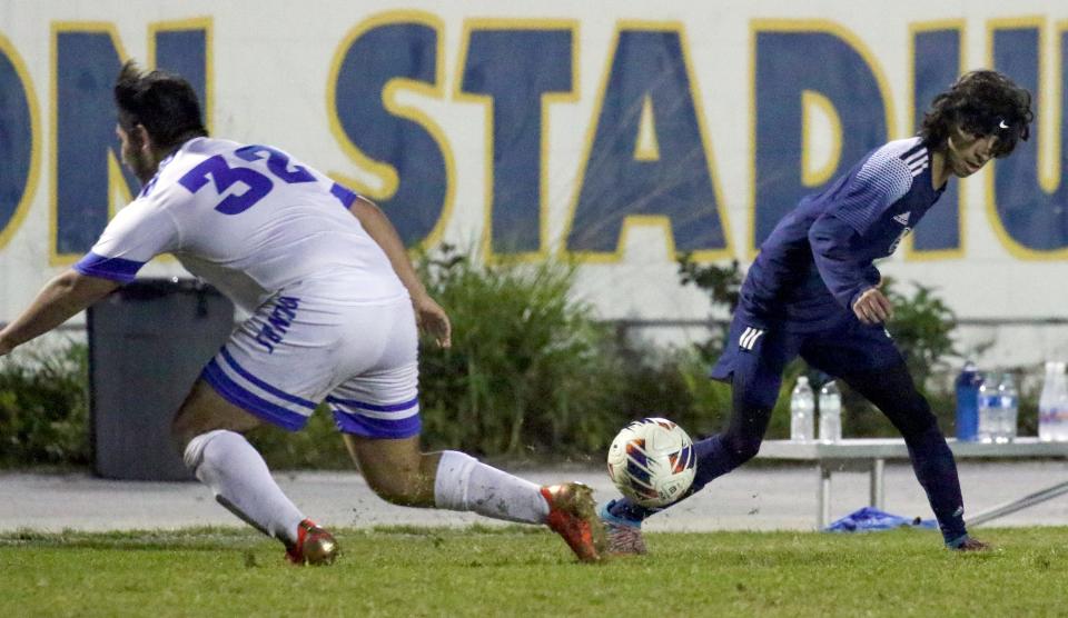 Winter Haven junior MacAlister Kranzler Ratcliffe takes possession of the ball from Auburndale junior Eric Sanchez on Wednesday night at Denison Stadium.