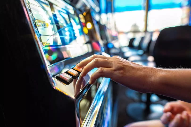 Stock image of person playing a slot machine
