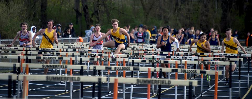 Louden Murbach (center) of Erie Mason wins the high hurdles against Summerfield and Whiteford Tuesday, April 18, 2023. From the left Josh Jensen of Summerfield, Logan Goodin of Mason, Teddy Gault of Summerfield, Louden Murbach of Mason, Seamus Waterford of Whiteford, Michael Narew of Mason and Ethan Albright of Mason.