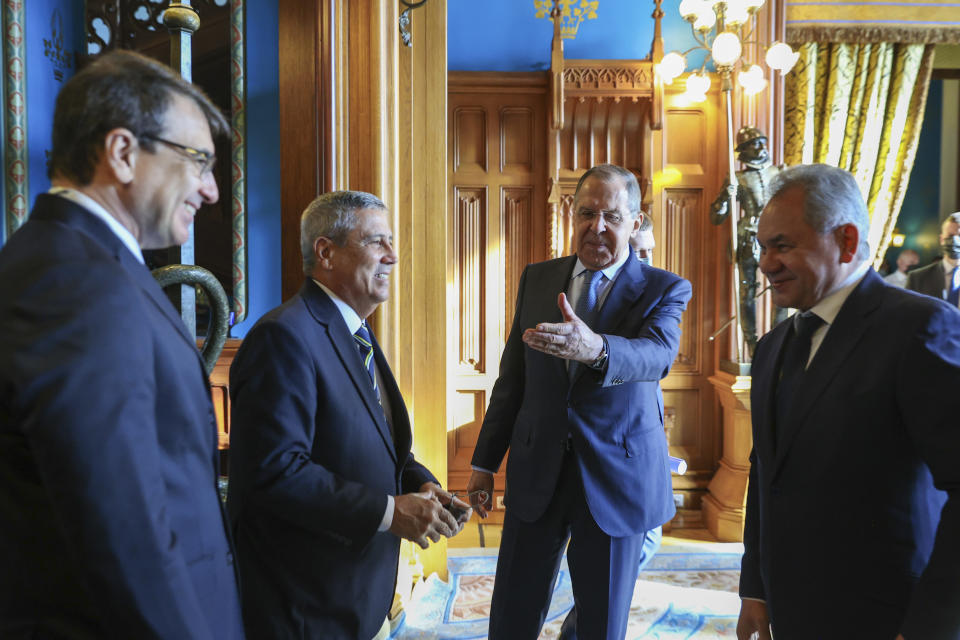 FILE - In this photo released by Russian Foreign Ministry Press Service, Russian Foreign Minister Sergey Lavrov, second right and Russian Defense Minister Sergei Shoigu, right, Brazil's Foreign Minister Carlos Franca, left, and Brazil's Defense Minister Walter Souza Braga Netto, second left, talk before talks in Moscow, on Feb. 16, 2022. (Russian Foreign Ministry Press Service via AP, File)